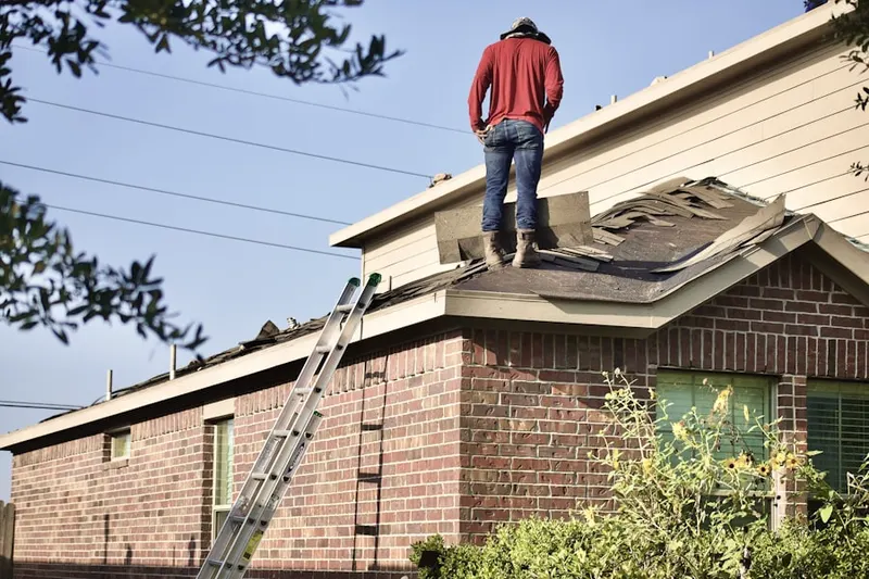 Professional roofer working on a residential roof in Moreno Knolls